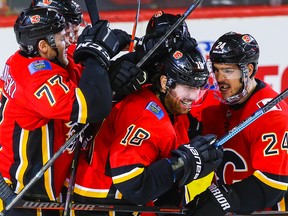 Calgary Flames James Neal is mobbed by teammates after scoring against the San Jose Sharks at the Scotiabank Saddledome in Calgary on Monday, Dec. 31, 2018.