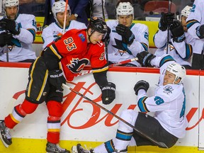 Calgary Flames forward Sam Bennett flattens San Jose Sharks Tomas Hertl at the Scotiabank Saddledome on Monday, Dec. 31, 2018.