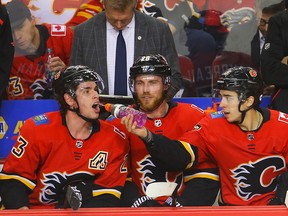 Calgary Flames Johnny Gaudreau celebrates with the purple Gatorade with teammates Sean Monahan and Elias Lindholm after scoring a power play goal against the San Jose Sharks at the Scotiabank Saddledome on Monday, Dec. 31, 2018.