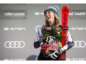 Mikaela Shiffrin, of the United States, celebrates her victory on the podium following the women's World Cup Super-G ski race at Lake Louise on Sunday. Photo by Jeff McIntosh/The Canadian Press.