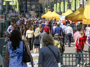 People crowd Stephen Avenue on a warm spring day.