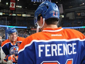 Taylor Hall and Andrew Ference of the Edmonton Oilers talk prior to a game against the Arizona Coyotes on Nov. 16, 2014, at Rexall Place in Edmonton.