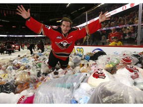 Calgary Hitmen Kaden Elder celebrates after scoring on Kamloops Blazers goalie Dylan Garand to start the bear toss during the 24th annual Brick Teddy Bear Toss game at the Scotiabank Saddledome in Calgary on Sunday December 9, 2018. Darren Makowichuk/Postmedia