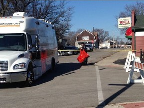 In this Sunday, Dec. 9, 2018 photo, police investigate after the body of a pregnant teenager was found in a dumpster behind a Mishawaka, Ind., restaurant. Authorities say a 16-year-old boy is suspected in the death of a 17-year-old pregnant schoolmate and was arrested Sunday. (Joseph Dits/South Bend Tribune via AP) ORG XMIT: INSBE201