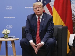 President Donald Trump listens to questions from members of the media during his meeting with Germany's Chancellor Angela Merkel at the G20 Summit, Saturday, Dec. 1, 2018 in Buenos Aires, Argentina.