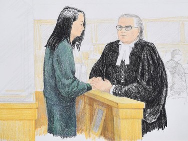 In this courtroom sketch, Meng Wanzhou, left, the chief financial officer of Huawei Technologies speaks to her lawyer David Martin during a bail hearing at B.C. Supreme Court in Vancouver, on Monday, December 10, 2018.