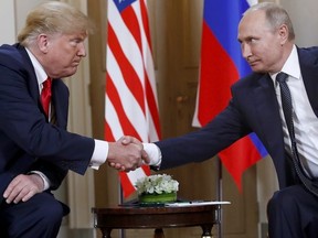 U.S. President Donald Trump, left, and Russian President Vladimir Putin shake hands at the beginning of a meeting at the Presidential Palace in Helsinki, Finland, on July 16, 2018.