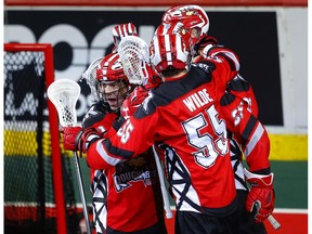 Calgary Roughnecks Chris Boushy, left, celebrates his goal on the Vancouver Warriors  with his teammates during their game at the Scotiabank Saddledome in Calgary, on Saturday December 15, 2018. Leah Hennel/Postmedia ORG XMIT: POS1812152216552634