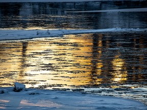 The last rays of 2018 turn the Bow River bronze on Monday, December 31, 2018. Mike Drew/Postmedia