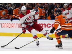 The Edmonton Oilers' Alex Chiasson (39) battles the Carolina Hurricanes' Dougie Hamilton (19) during second period NHL action at Rogers Place, in Edmonton Sunday Jan. 20, 2019. Photo by David Bloom