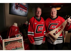 The early 70's Centennials players Mike Rogers, left and Jerry Holland pose for a portrait at the Scotiabank Saddledome in Calgary in the days leading up to The Corral Series. Photo by Leah Hennel/Postmedia.
