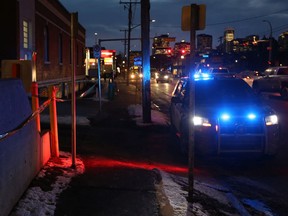 Police block off  alley behind the 100 block of 15 Street N.W. in Hillhurst after an overnight shooting death on Tuesday January 22, 2019.