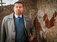 The general manager of the archaeological park of Pompeii, Massimo Osanna, stands by a fresco at the Schola Armaturarum building in Pompeii, Italy, Thursday, Jan. 3, 2019. (Cesare Abbate/ANSA via AP)