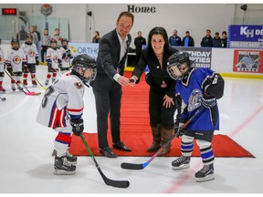 Brian Malkinson the MLA for Calgary Currie and Imperial Field Marketing Advisor, Susan Di Giorgio drop the puck between Ryan Shaw of the Northwest Warriors and Owen Martin of the Lake Bonavista Breakers during the opening ceremonies of Esso Minor Hockey Week on Saturday, January 12, 2019 at Flames Community Arena. Al Charest/Postmedia