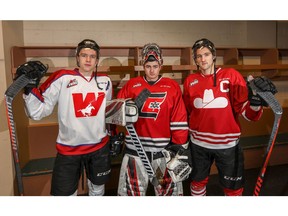 Calgary Hitmen captain Mark Kastelic wearing the Cowboys jersey, goalie Jack McNaughton wearing the Centennials jersey and captain Mark Kastelic wearing the Cowboys jersey. The players posed for a photo to promote the upcoming Corral Series, which features three regular-season games played in the Corral with the Hitmen dressing in uniforms of historic teams from Calgary's hockey past.  Photo by Al Charest/Postmedia.