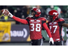 Calgary Stampeders running back Terry Williams (38) celebrates a punt return touchdown against the Ottawa Redblacks with teammate defensive back Tunde Adeleke (27) during the first half of the 106th Grey Cup in Edmonton, Alta. Sunday, Nov. 25, 2018. One of the heroes of the Calgary Stampeders' 2018 Grey Cup win is staying with the CFL team. Terry Williams, who returned a punt 97 yards for a touchdown in the Stamps' Grey Cup victory over the Ottawa Redblacks, re-signed with the team on Friday.