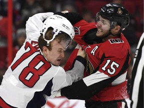 Ottawa Senators left wing Zack Smith (15) knocks off the helmet of Washington Capitals defenceman Tyler Lewington (78) as they fight during second period NHL hockey action in Ottawa, Saturday December 29, 2018.