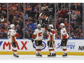 Calgary Flames' Mikael Backlund (11), Michael Frolik (67), Rasmus Andersson (4) and James Neal (18) celebrate a goal during second period NHL action against the Edmonton Oilers, in Edmonton on Saturday, Jan. 19, 2019.