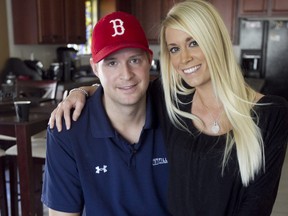 In this Feb. 3, 2012, file photo, Iraq War veteran Brian Kolfage, left, sits with his wife Ashley Kolfage at their Tucson, Ariz., home. (AP Photo/The Arizona Republic, Pat Shannahan, file)