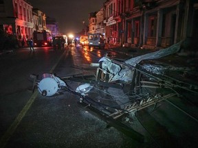 A fallen utility pole is seen among debris in the tornado-hit Luyano neighbourhood in Havana early on January 28, 2019. - A tornado hit several neighborhoods in Havana overnight on January 28, disrupting electrical power and damaging buildings and cars, with no clear reports of casualties thus far.