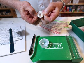 Pharmacist Kent Wood prepares a prescription of Suboxone in the pharmacy in Standoff, Alberta on Tuesday February 28, 2017. The business on the Blood Reserve has been overwhelmed with Suboxone patients and has had to cap the number of clients it can handle at 70 per day. GAVIN YOUNG/POSTMEDIA NETWORK