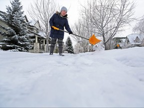 A woman who declined to give her name clears the sidewalk in front of her Pleasant Heights home on Thursday, January 17, 2019. Gavin Young/Postmedia