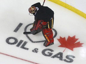 Calgary Flames skate at the Saddledome in Calgary Thursday, January 10, 2019. A new on ice sign has been painted in two of the corners supporting oil and gas. Jim Wells/Postmedia