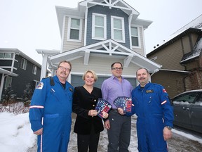 (L-R) Pilot Phil Haworth, STARS CEO Andrea Robertson, former patient Marc Issler and flight paramedic Ron Pasieka pose in front of the STARS Lottery Calgary show home in the community of Riverstone in Cranston during the launch of the 26th edition of the STARS lottery in Calgary on Thursday, Jan. 17, 2019.