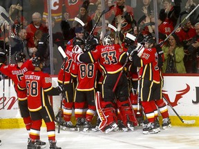 Calgary Flames Mikael Backlund is mobbed after scoring the overtime winner on the Carolina Hurricanes at the Scotiabank Saddledome on Tuesday, Jan. 22, 2019.