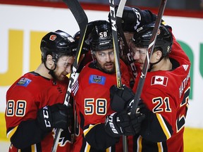 Flames defenceman Oliver Kylington, centre, celebrates his goal in the first period against the Carolina Hurricanes, in Calgary, Tuesday, Jan. 22, 2019.