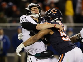 CHICAGO, ILLINOIS - JANUARY 06: Khalil Mack #52 of the Chicago Bears hits Nick Foles #9 of the Philadelphia Eagles in the fourth quarter of the NFC Wild Card Playoff game at Soldier Field on January 06, 2019 in Chicago, Illinois. (Photo by Jonathan Daniel/Getty Images)