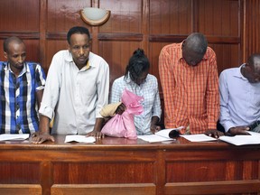 From left to right, suspects Osman Ibrahim, Guleid Abdihakim, Gladys Kaari Justus, Oliver Kanyango Muthee and Joel Nganga Wainaina appear at a hearing at Milimani law courts in Nairobi, Kenya Friday, Jan. 18, 2019. Police who are investigating this week's extremist attack on a Nairobi hotel complex asked the court that the suspects who are accused of involvement in the attack be held for 30 days in order for the police to complete their investigations, which the court granted. (AP Photo)