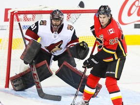 Calgary Flames Sean Monahan attempts to deflect a puck past of the Arizona Coyotes Adin Hill during NHL hockey at the Saddledome on Sunday, Jan. 13, 2019.