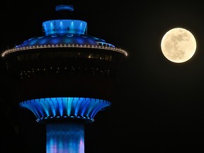 A full moon rises behind the Calgary Tower on Feb. 22, 2016. A "super blood wolf moon" should be visible over Calgary on Sunday.