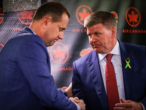 Calgary Flames GM Brad Treliving and the team's new head coach Bill Peters during a press conference in the Ed Whalen Media Lounge at the Scotiabank Saddledome in Calgary.
