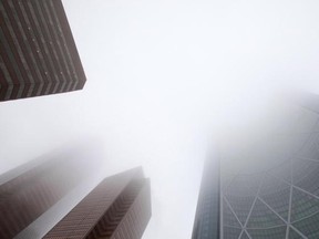 Environment Canada has issued a fog advisory for Calgary. Expect near zero visibility in the early hours, so commuters should take their time, drive slow and watch for tail lights of other vehicles. Fog envelopes downtown Calgary and the Suncor and Encana Bow towers on Sunday morning March 26, 2012. (Gavin Young/Calgary Herald)