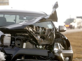 Pickup truck damaged by a wheel which came off a semi-trailer on Stoney Trail near Deerfoot Trail on Thursday, Jan. 10, 2019.