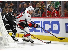 CHICAGO, ILLINOIS - FEBRUARY 18: Mark Stone #61 of the Ottawa Senators is pressured by Slater Koekkoek #68 of the Chicago Blackhawks at the United Center on February 18, 2019 in Chicago, Illinois.