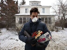 Alex Archbold poses with a few of the items he salvaged from a home in north eastern Alberta, Monday Jan. 28, 2019. Archbold recently purchased the home and it's entire contents and is slowly unpacking the valuable contents on his YouTube channel.