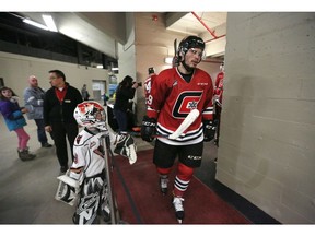 Dominic Karkkainen, 8,  greets Calgary Hitmen Egor Zamula after first period at the Stampede Corral in Calgary, on Friday February 1, 2019, during a retro jersey game against the Brandon Wheat Kings. Leah Hennel/Postmedia