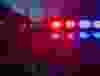 Red and blue Lights of police car in night time. Night patrolling the city. Abstract blurry image.
