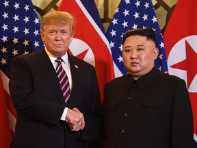 U.S. President Donald Trump, left, shakes hands with North Korea's leader Kim Jong Un before a meeting at the Sofitel Legend Metropole hotel in Hanoi on Feb. 27, 2019. (SAUL LOEB/AFP/Getty Images)
