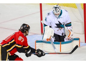 San Jose Sharks goaltender Martin Jones makes a save on a shot by Michael Frolik of the Calgary Flames during NHL hockey at the Scotiabank Saddledome in Calgary on Thursday, February 7, 2019. Al Charest/Postmedia
