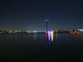 In this photo provided by Kasia Gregorczyk, more than a dozen people are trapped on a ride at SeaWorld Monday, Feb. 18, 2019, in San Diego. San Diego police tell FOX5 News that around six gondolas stopped functioning Monday night after a big gust of wind tripped a circuit breaker on "Bayside Skyride."