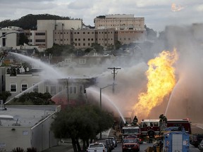 San Francisco firefighters battle a fire on Geary Blvd. in San Francisco, Wednesday, Feb. 6, 2019.