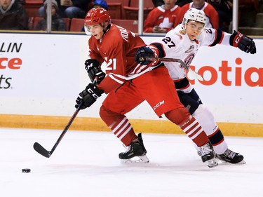 The Calgary Hitmen's Riley Fiddler-Schultz and the Regina Pats' Nikita Sedov battle for control of the puck during WHL action in The Corral Series on Wednesday February 6, 2019. The Hitmen wore Calgary Cowboys jerseys for the game.