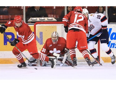 The Calgary Hitmen's Layne Toder clears the puck from in front of goaltender Jack McNaughton and the Regina Pats during WHL action in The Corral Series on Wednesday February 6, 2019. The Hitmen wore Calgary Cowboys jerseys for the game.