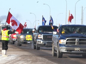 Martin Zobrist greets truckers and supporters as he stands on Highway 1 in Strathmore, AB, 45 km east of Calgary on Thursday, February 14, 2019 as the United We Roll convoy for Canada is eastbound to Ottawa. Zobrist said he left work in Calgary for the day. Jim Wells/Postmedia