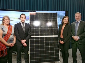 (L-R) Shirley Tremblay, president of Metis local 193, Ryan Tourigny, fCanadian Solar Shannon Phillips, Minister of Environment and Parks and John Gorman, CEO and President of Canadian Solar Industry Association pose for media in Calgary on Friday, February 15, 2019.The Government of Alberta has awarded a historic 20 year contract to supply government facilities with solar power from three facilities between Medicine Hat and Calgary. Candian Solar is building the new facilites in partnership with Conklin Metis Local 193 as 50-percent equity owners. Friday, February 15, 2019. Jim Wells/Postmedia