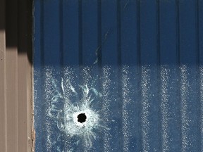 A bullet hole is shown on the exterior of a front window at Varsity Acres Presbyterian Church on Varsity Drive N.W. in Calgary on Thursday, February 21, 2019. The church was hit sometime early Wednesday night. There were no injuries.